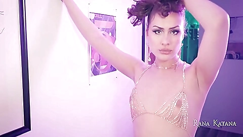 Brunette is on her knees and her ass is stuffed by a toy